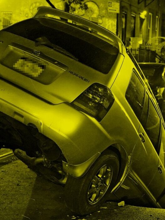 A parked car fallen in a sink hole. Photo: Christopher Sadowski, 2020.