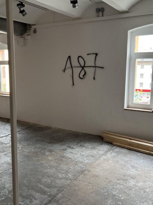 Graffiti on the wall of a space allocated to the Question of Funding collective, documenta fifteen, 2022. Referencing the California Penal Code, “187” is slang for murder.