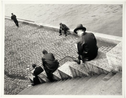 Ilse Bing, Three Men Sitting on the Steps by the Seine, 1931. International Center of Photography, New York, donation of Ilse Bing, 1991. © Estate of Ilse Bing.