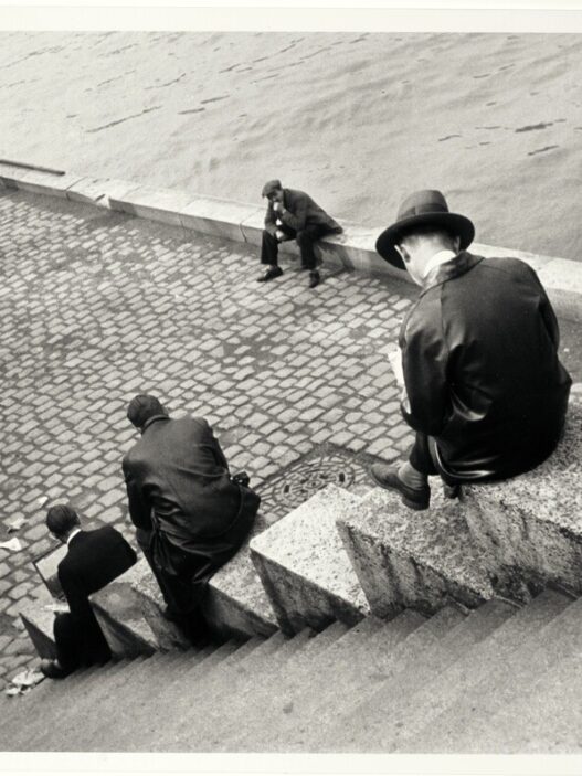 Ilse Bing, Three Men Sitting on the Steps by the Seine, 1931. International Center of Photography, New York, donation of Ilse Bing, 1991. © Estate of Ilse Bing.