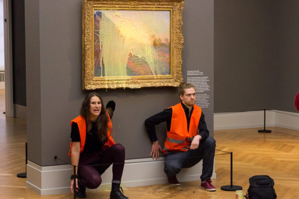 Letzte Generation protesters in front of the potato-splashed Monet painting. COURTESY LETZTE GENERATION