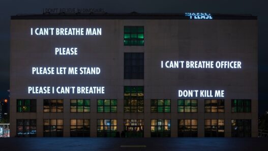 Jenny Holzer, IN MEMORIAM, 2020. Light projection, Hamburger Kunsthalle, Hamburg, Germany. Text: transcription of George Floyd’s last words plus 115 names of Black individuals who lost their lives to police violence and/or other forms of racial violence. © 2022 Jenny Holzer, member Artists Rights Society (ARS), NY / VG Bild-Kunst, Bonn 2022. Photo: Christoph Irrgang.